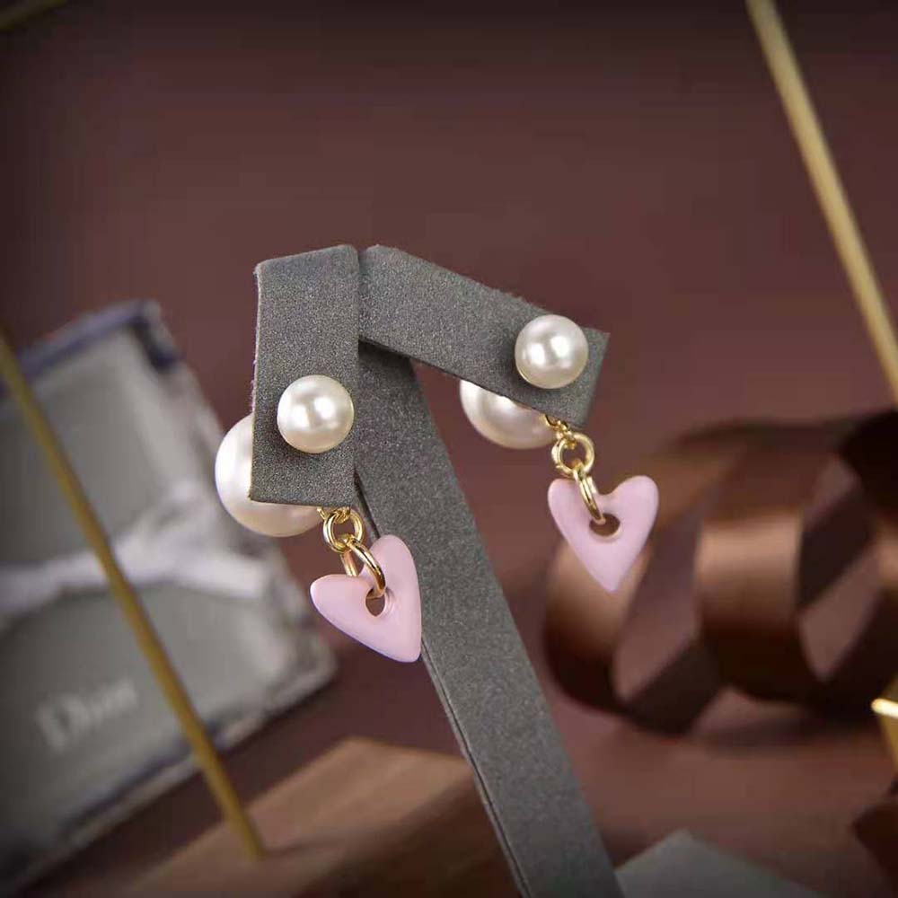 Dior Women Tribales Earrings worn with soft pink and gold light reflection