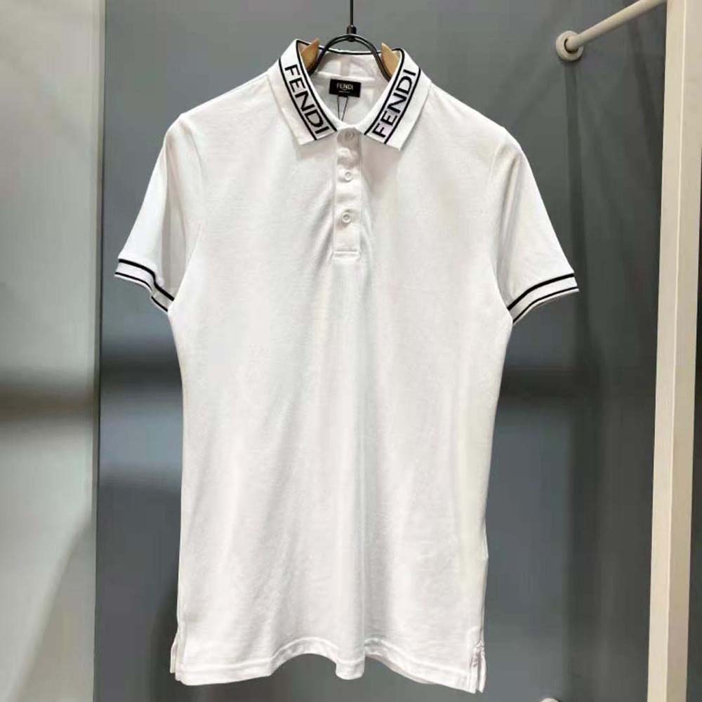 Close-up detail of Fendi logo on chest of white polo shirt