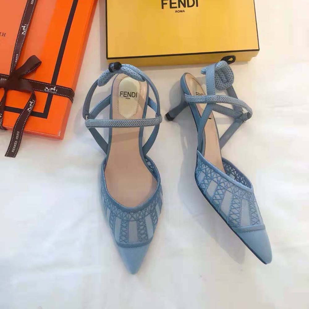 Close-up on gold-tone Fendi logo on slingback strap in light blue micromesh