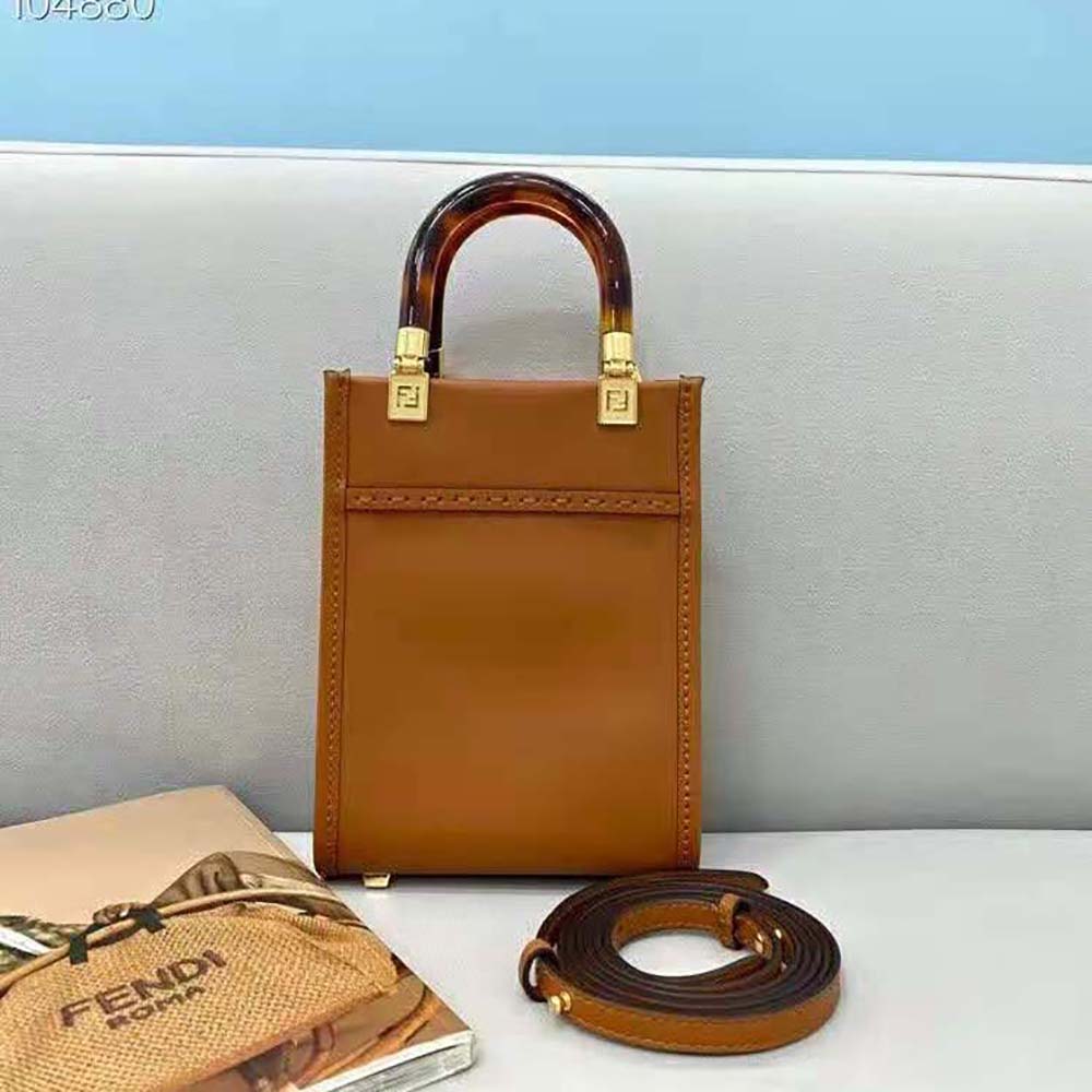 Side angle showing silhouette of Fendi Women Mini Sunshine Shopper dark brown mini-bag