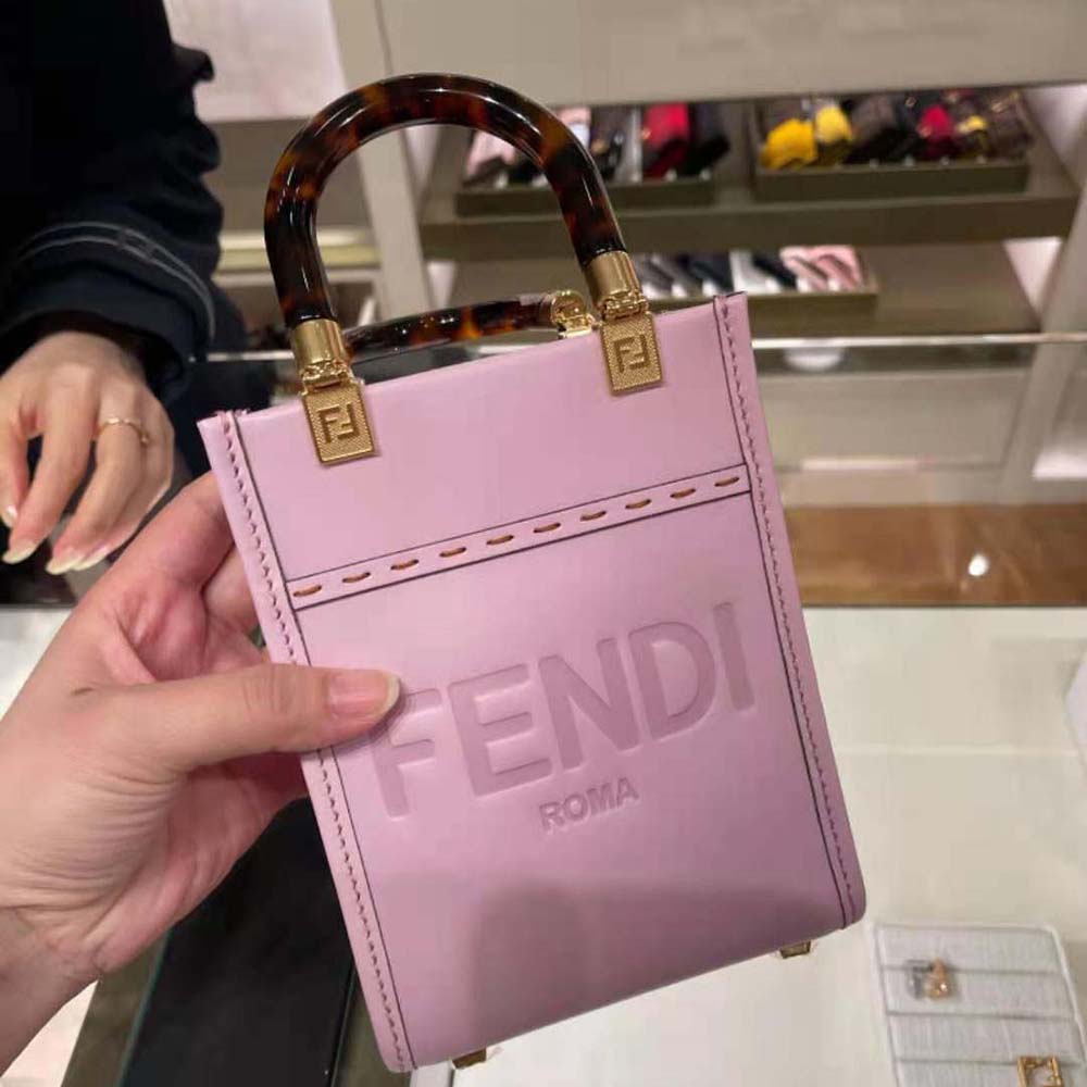 Close-up of gold-tone hardware and pink leather texture on Fendi mini-bag
