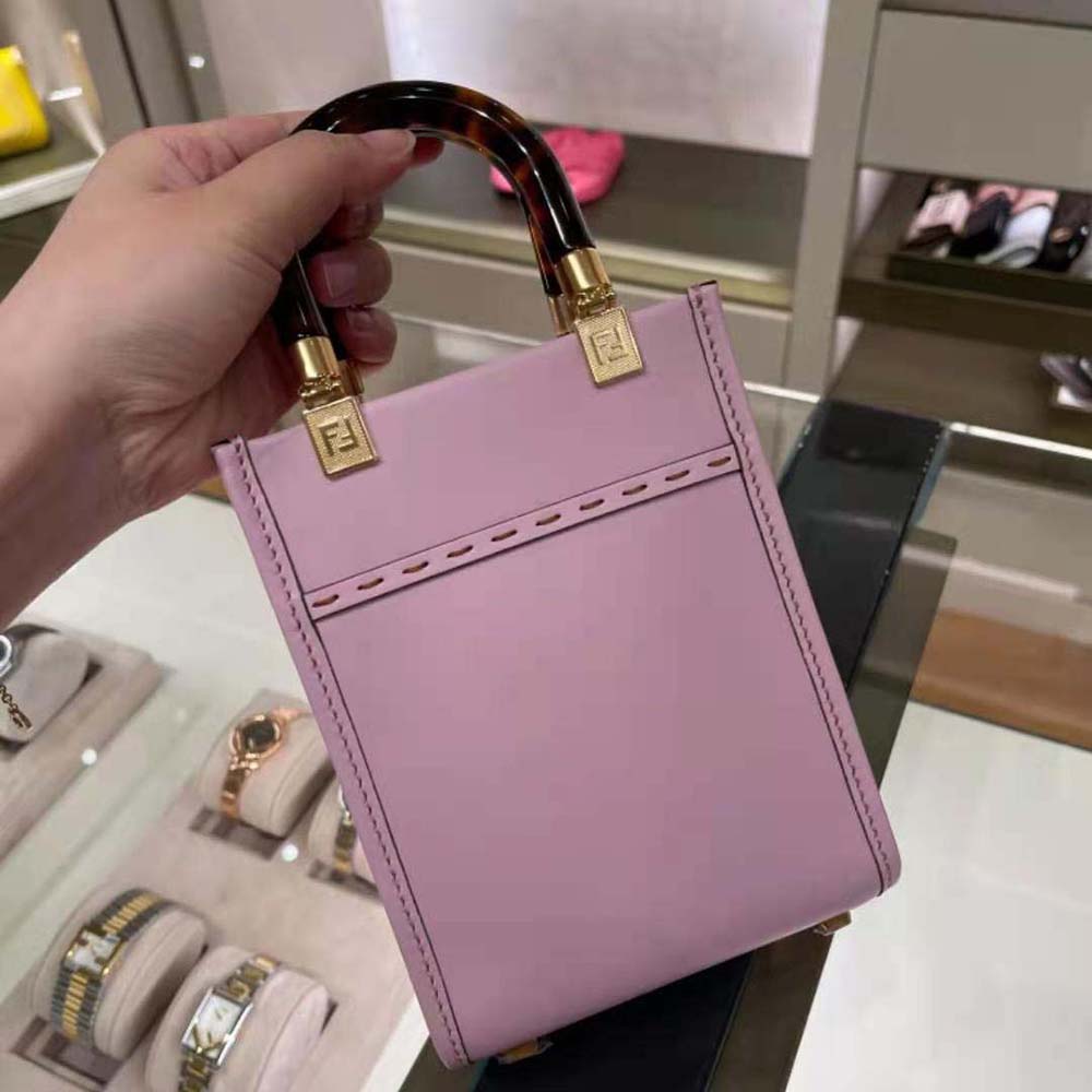 Side angle of Fendi Women Mini Sunshine Shopper Leather Mini-Bag-Pink with strap detail