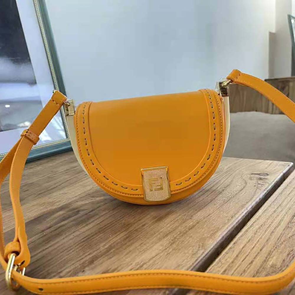Close-up of gold-tone hardware on Fendi Women Moonlight Orange Leather Bag