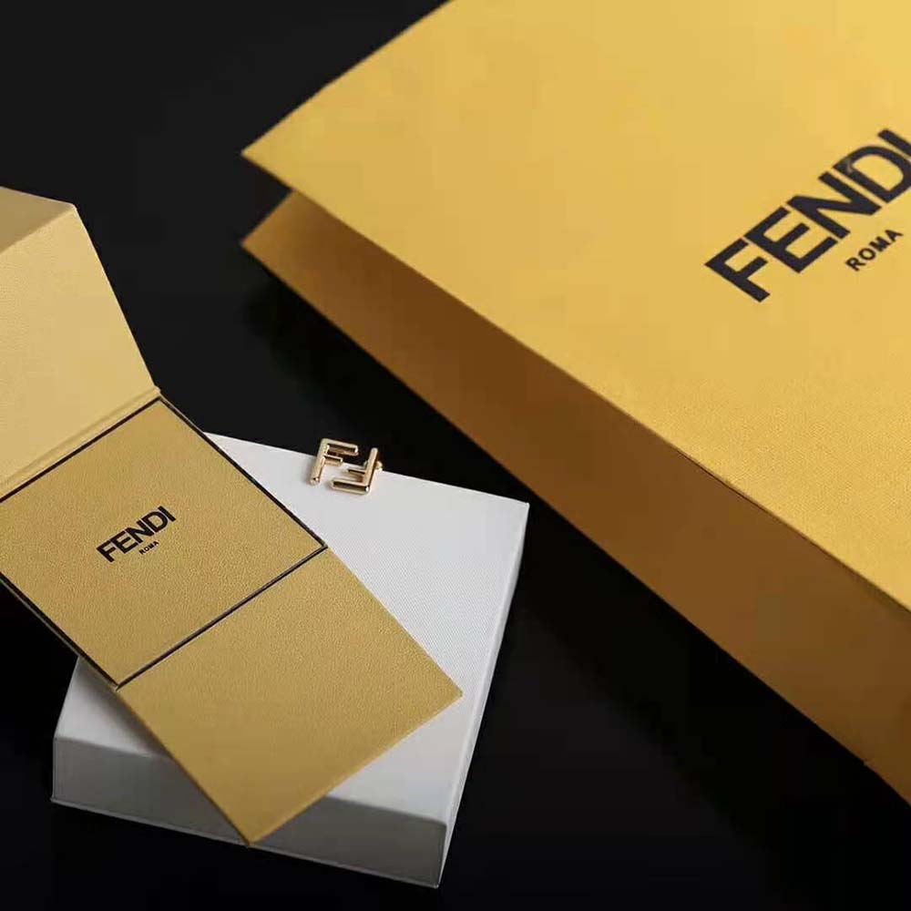 Close-up of polished gold-tone metal on Fendi Women Small FF Earrings