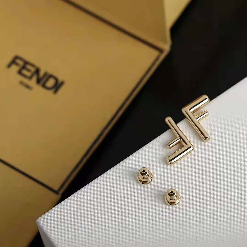 Side angle of Fendi Women Small FF Gold-color Earrings highlighting compact design