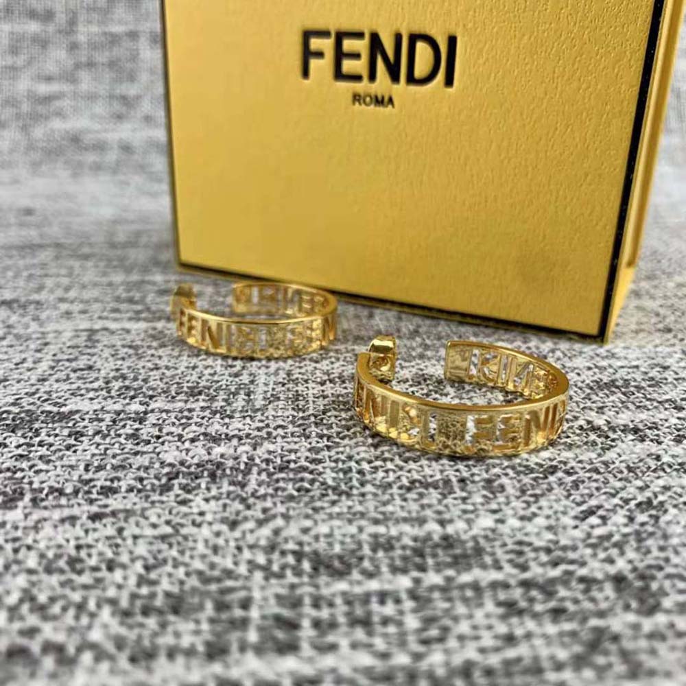 Close-up of gold-tone finish on Fendi Women Small Signature Earrings