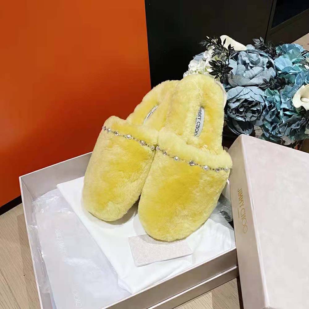 Side view showing slip-on silhouette of Jimmy Choo Women Aliette yellow slippers
