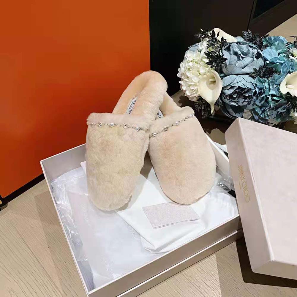 Side profile showing flat sole and Jimmy Choo embossing on slippers