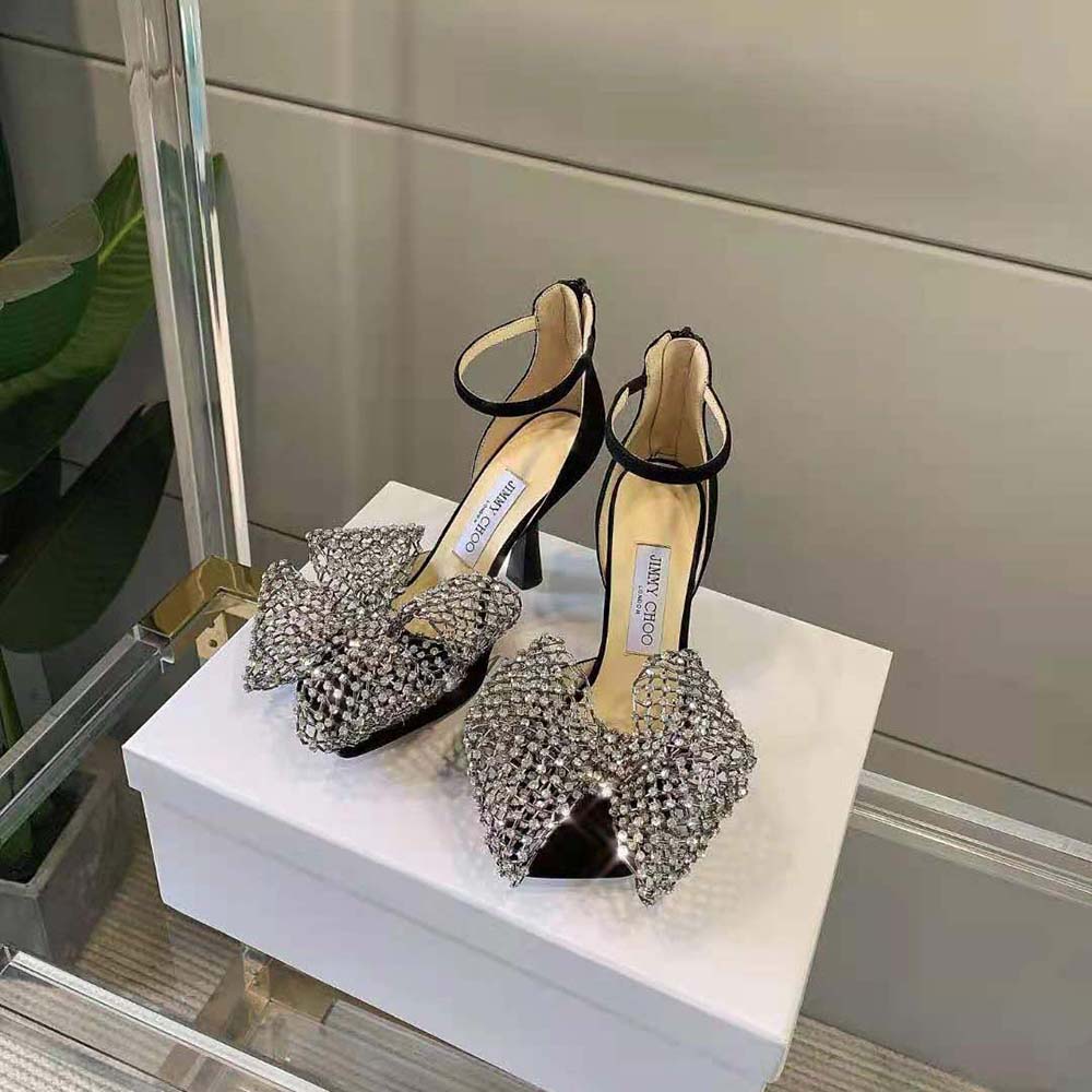 Close-up on crystal bow clasp detail of Jimmy Choo Women Mana 100 sandals