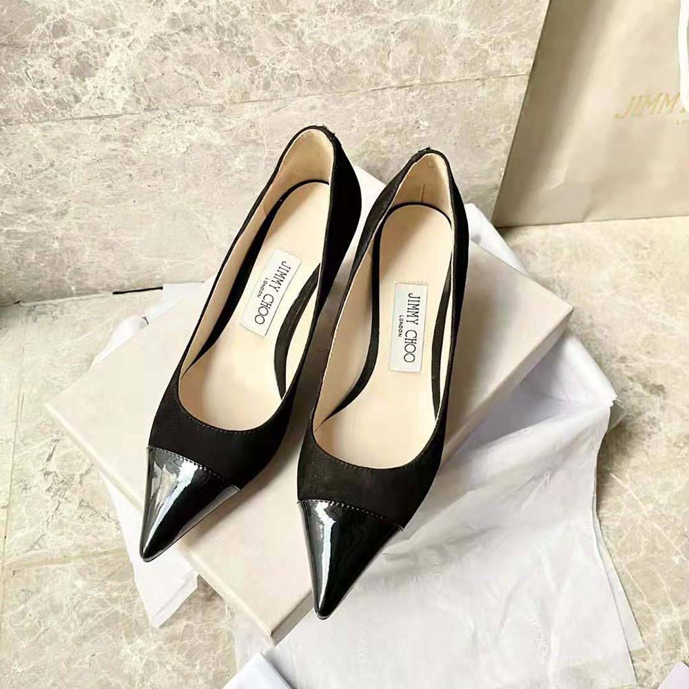 Close-up on pointed toe and mixed black suede, patent leather details