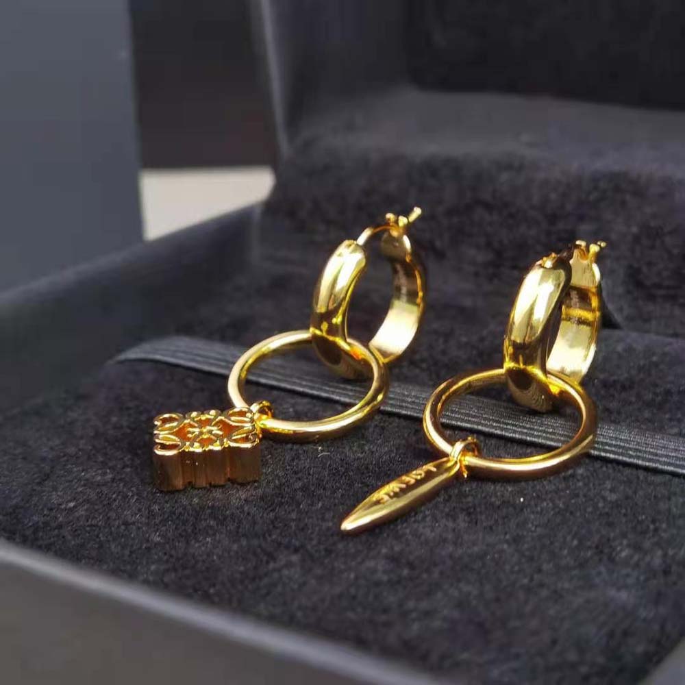 Close-up detail of Loewe Anagram motif on asymmetric earrings