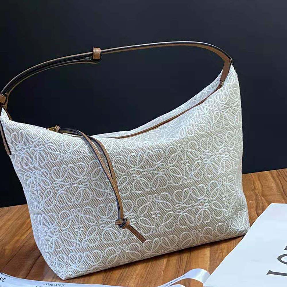 Side angle showing structured silhouette of Loewe Women Cubi Bag beige