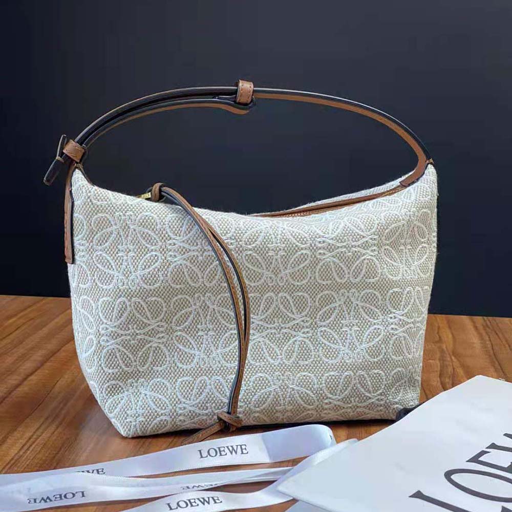 Side angle showing adjustable strap and silver-tone hardware on Loewe Small Cubi Bag