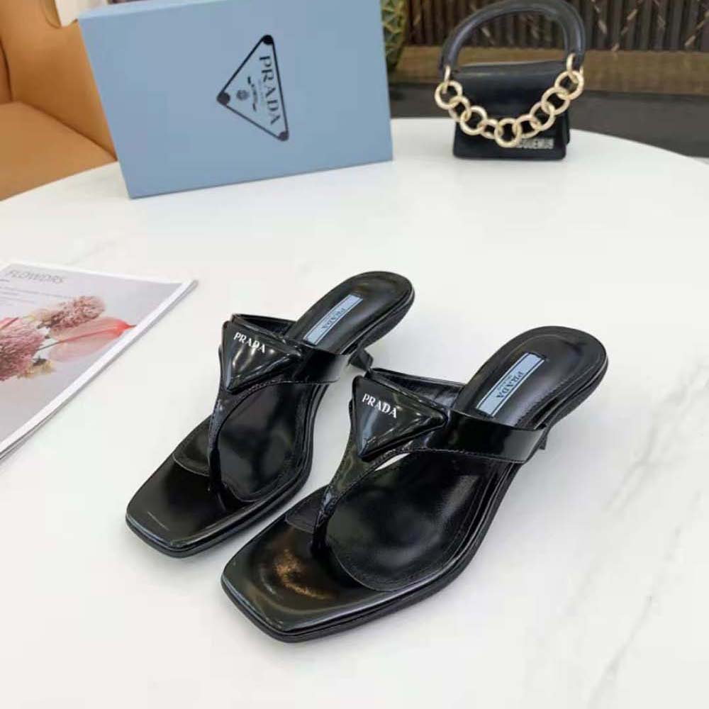 Rear angle showing stiletto heel and leather sole of Prada sandals