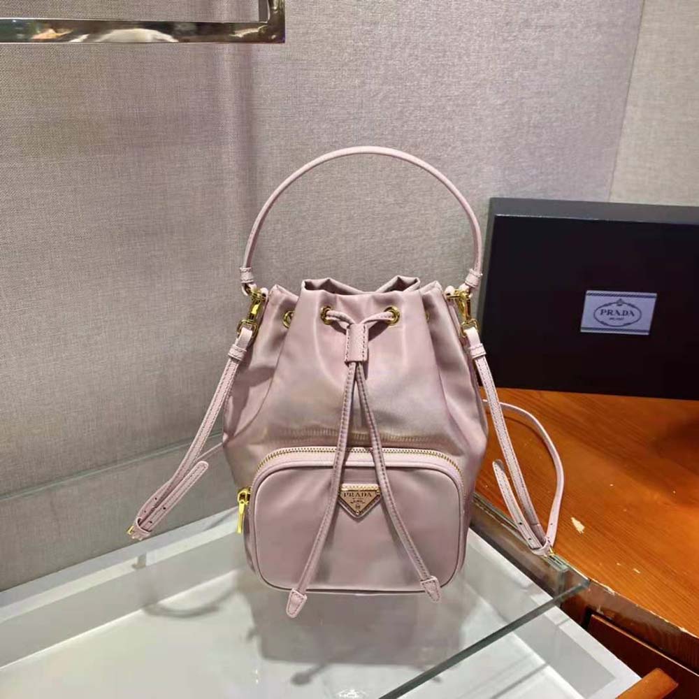 Close-up detail of pink Re-Nylon fabric and Prada logo on shoulder bag
