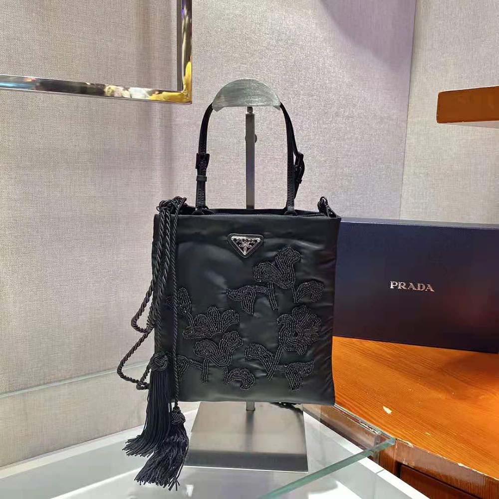 Side angle showing compact silhouette of Prada Women Embroidered Nylon Handbag-Black