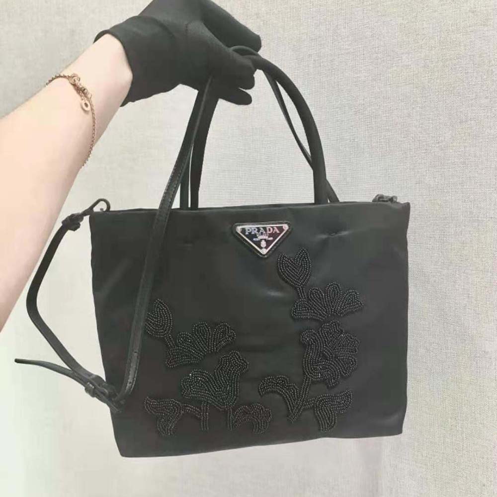 Close-up of embroidery and silver hardware on Prada handbag
