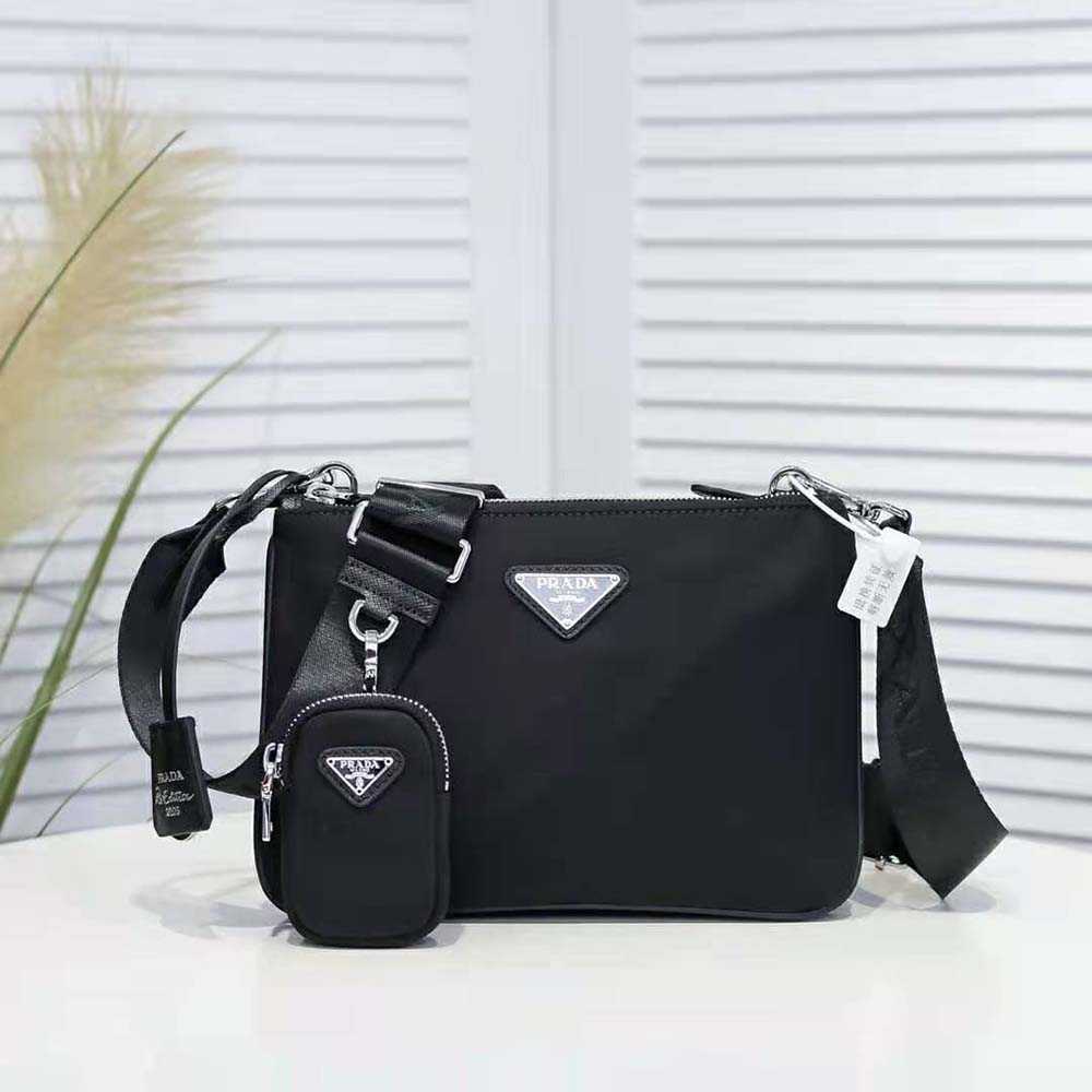Close-up on Prada triangle logo plaque on black nylon shoulder bag