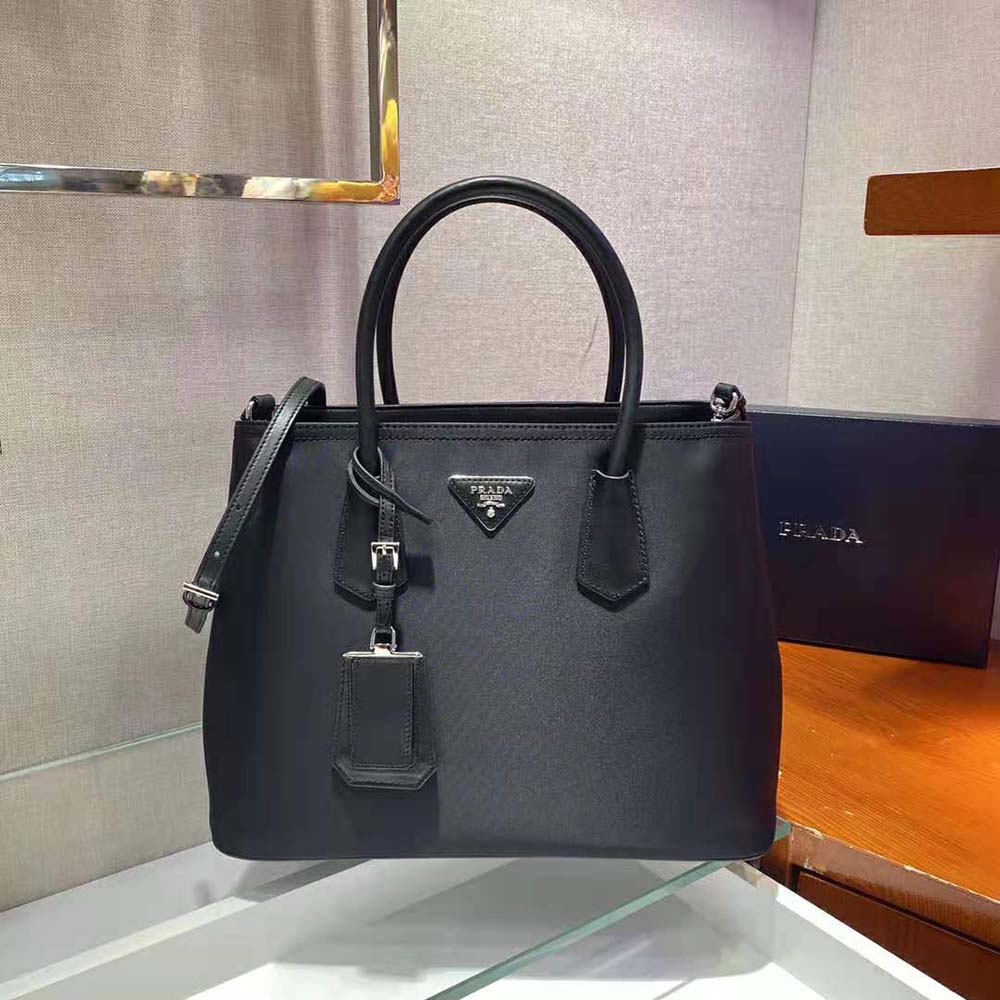 Close-up of signature Prada logo and magnetic closure detail