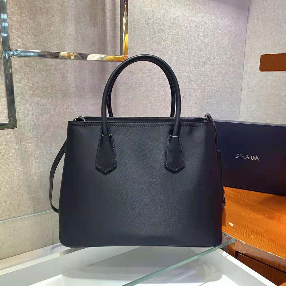 Side angle showing nylon texture and leather trim on Prada bag