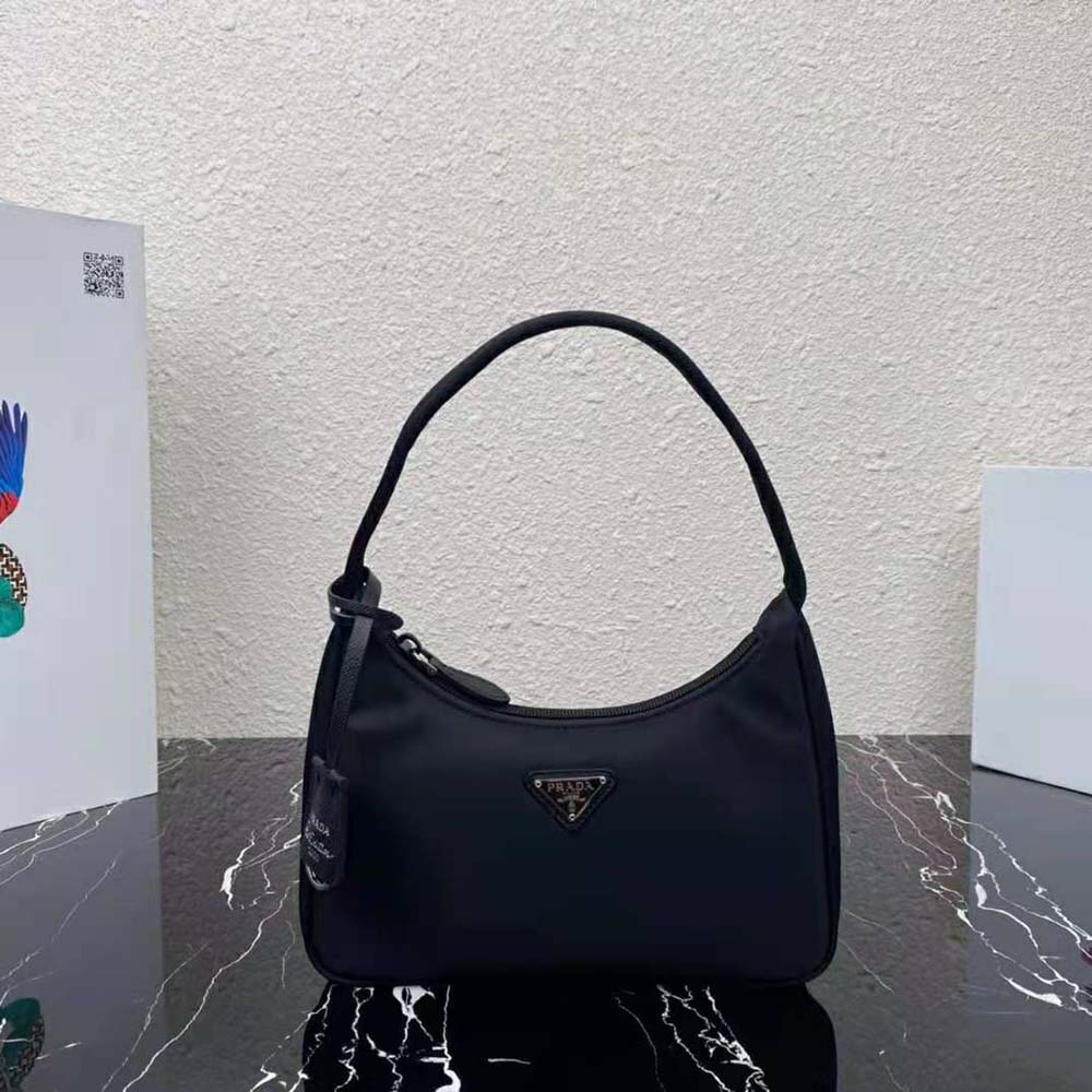 Close-up of Prada triangle logo on Re-Nylon Mini-Bag Black