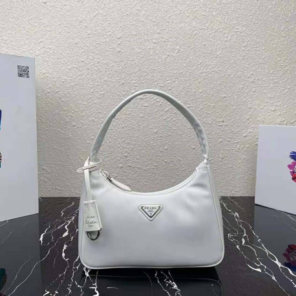 Close-up of silver-tone zipper and white Re-Nylon fabric on Prada mini-bag