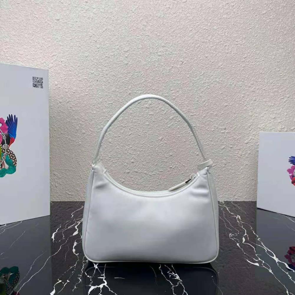 Side angle showing compact silhouette of Prada Women Re-Nylon Re-Edition 2000 Mini-Bag-White
