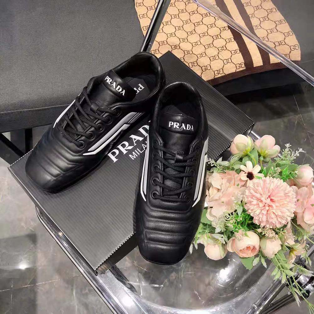 Close-up on lace and Prada logo of Prada Women Rev Leather Sneakers-Black