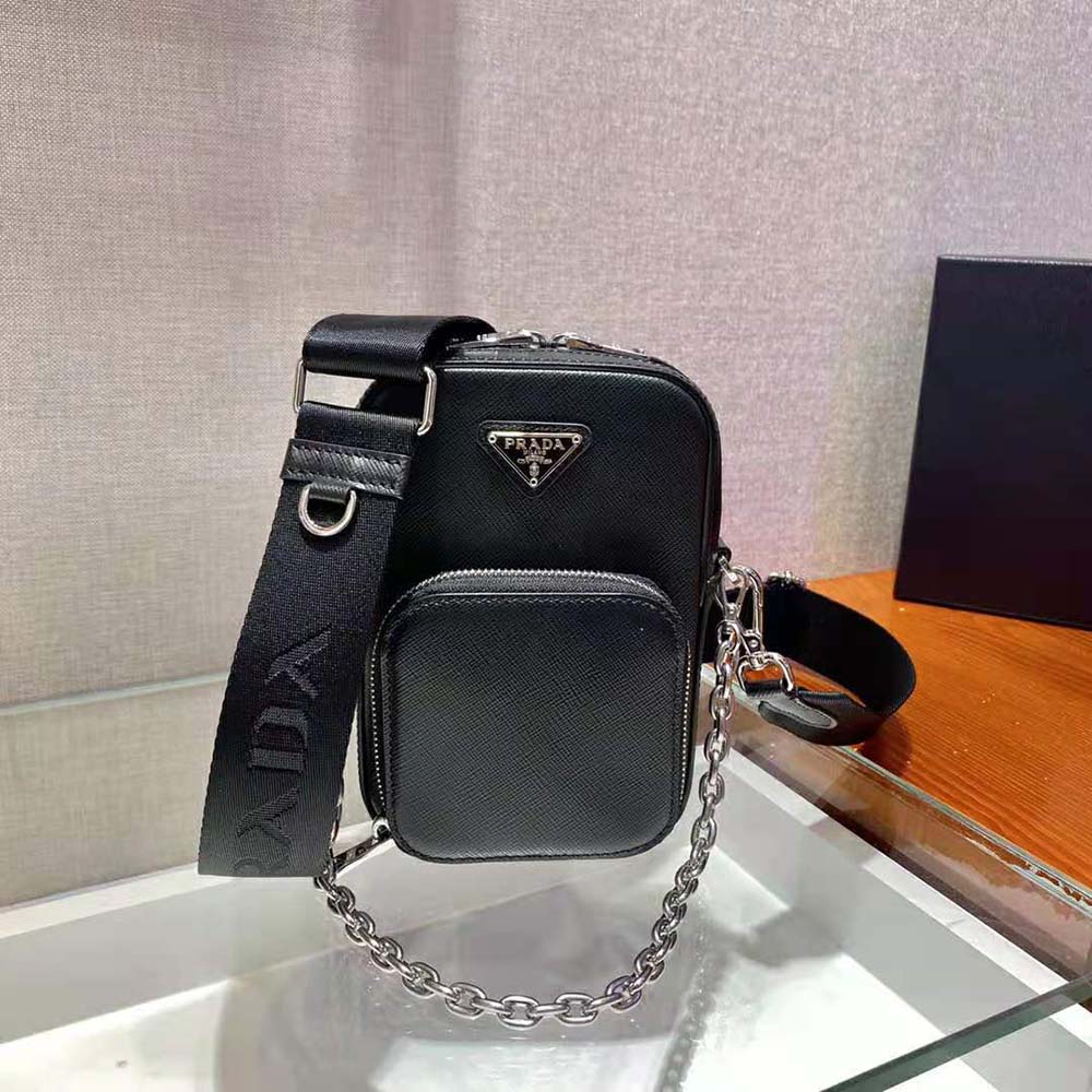 Close-up detail of black textured leather and silver hardware on Prada mini bag