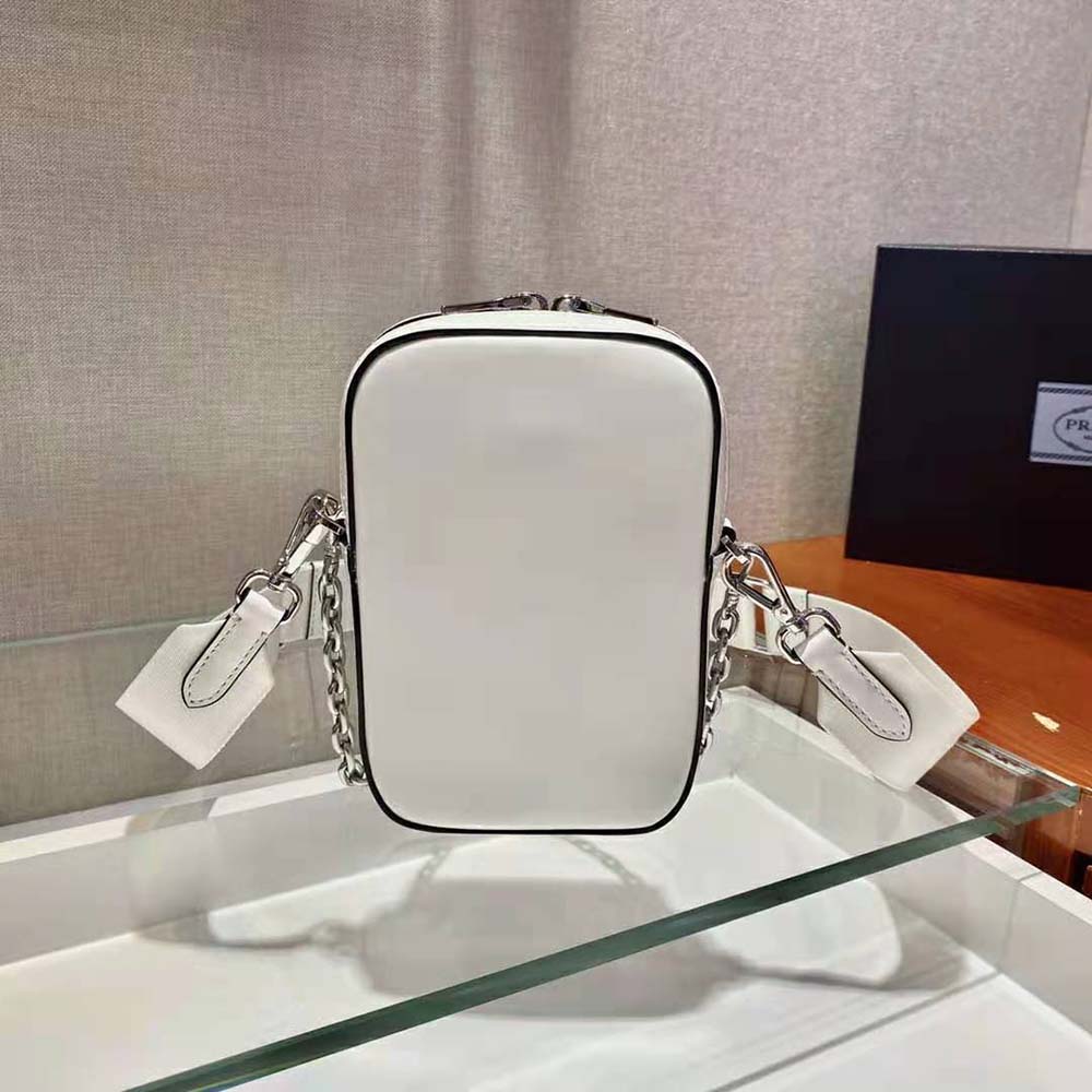 Side angle showing slim silhouette of Prada Women Saffiano Leather Mini Bag-White