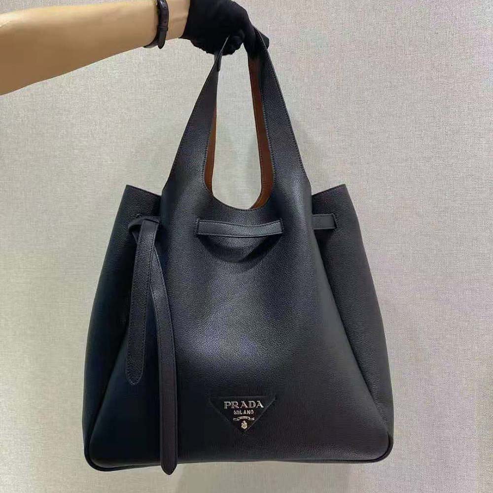 Close-up of black soft leather texture and polished Prada hardware