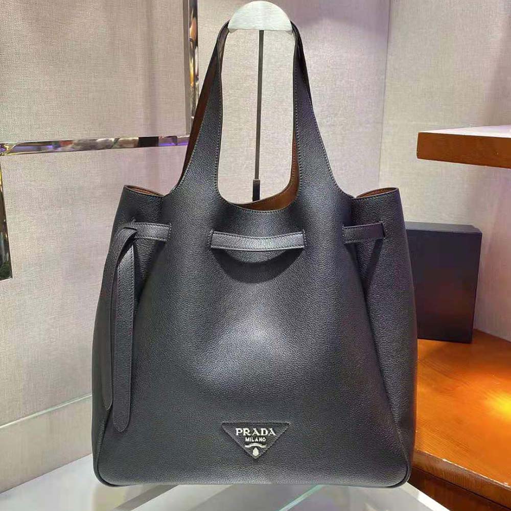 Side angle of Prada Women Soft Leather Tote-Black highlighting zipper closure