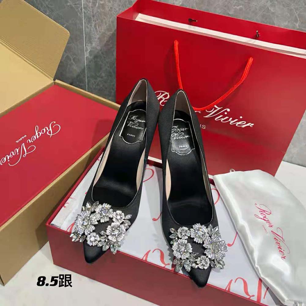Close-up of sparkling strass buckle on Roger Vivier Satin-Black pumps