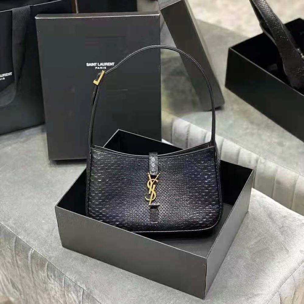 Close-up of gold YSL logo hardware on matte python black hobo bag