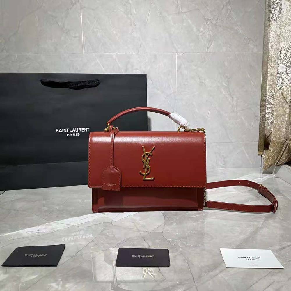 Close-up on gold YSL logo hardware of Saint Laurent YSL Medium Sunset Satchel