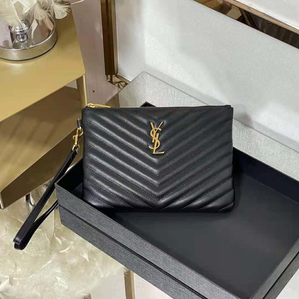 Close-up of YSL gold-tone monogram on black matelassé leather pouch