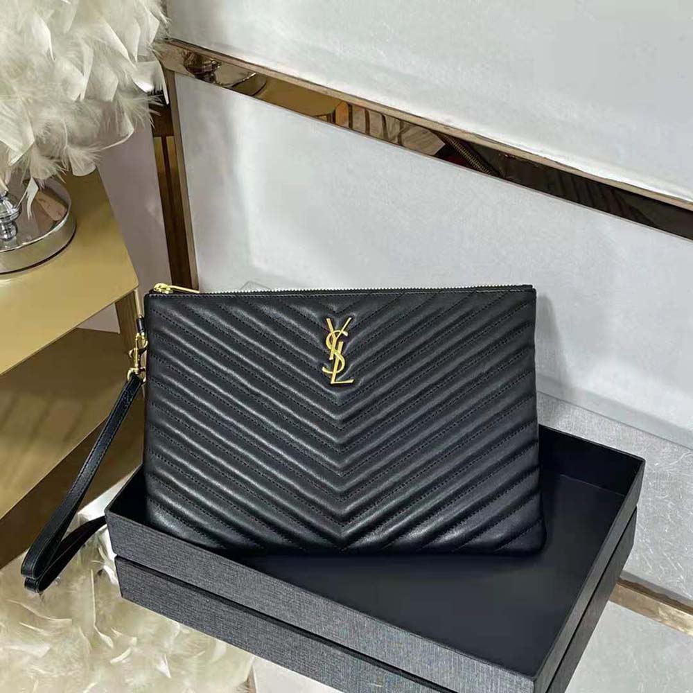 Close-up detail of gold YSL monogram on tablet pouch leather