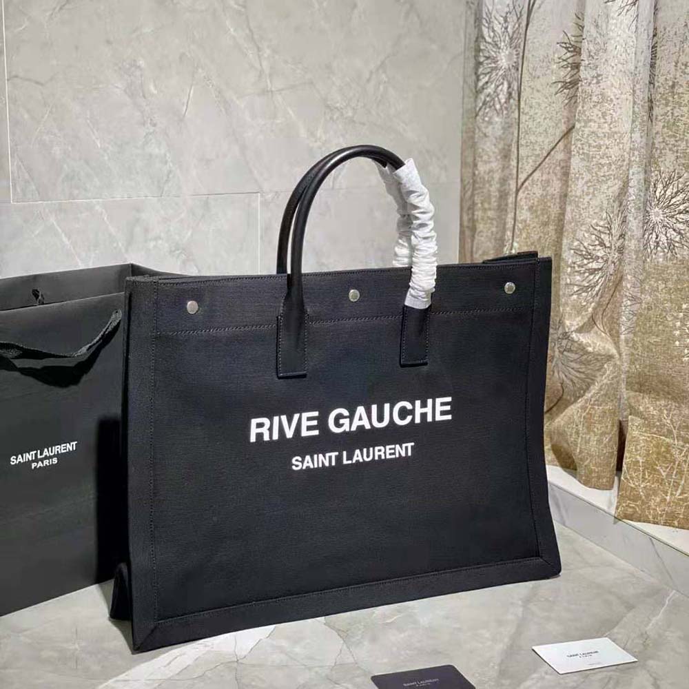 Side angle showing smooth leather handles of Saint Laurent YSL Women Rive Gauche Tote Bag