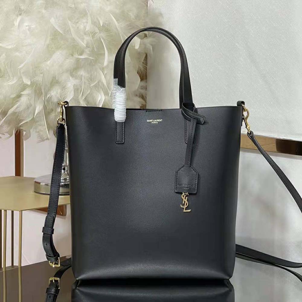 Close-up of gold YSL logo hardware on black Saint Laurent Toy handbag