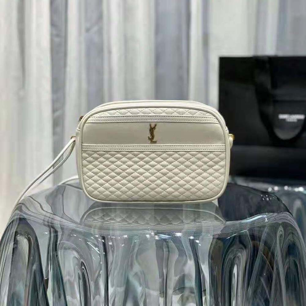 Close-up detail of YSL gold logo and quilted lambskin texture