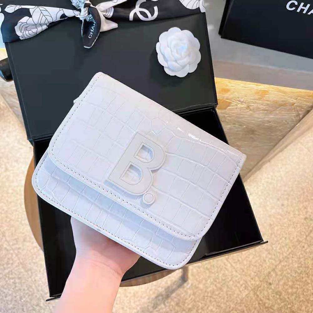 Side angle showing adjustable strap on Balenciaga Women B. Small Bag white shoulder bag