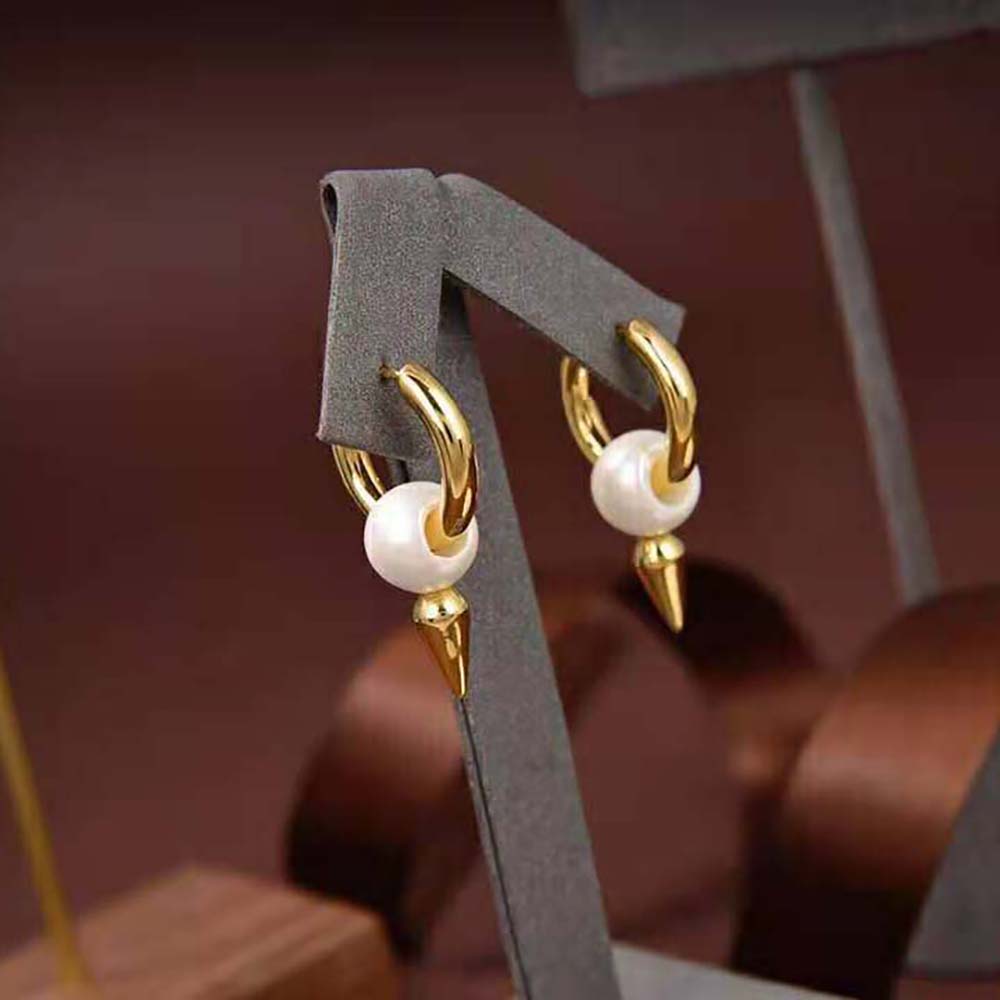 Side profile showing white acrylic and push-back closure on Balenciaga Women Force Spike Earrings