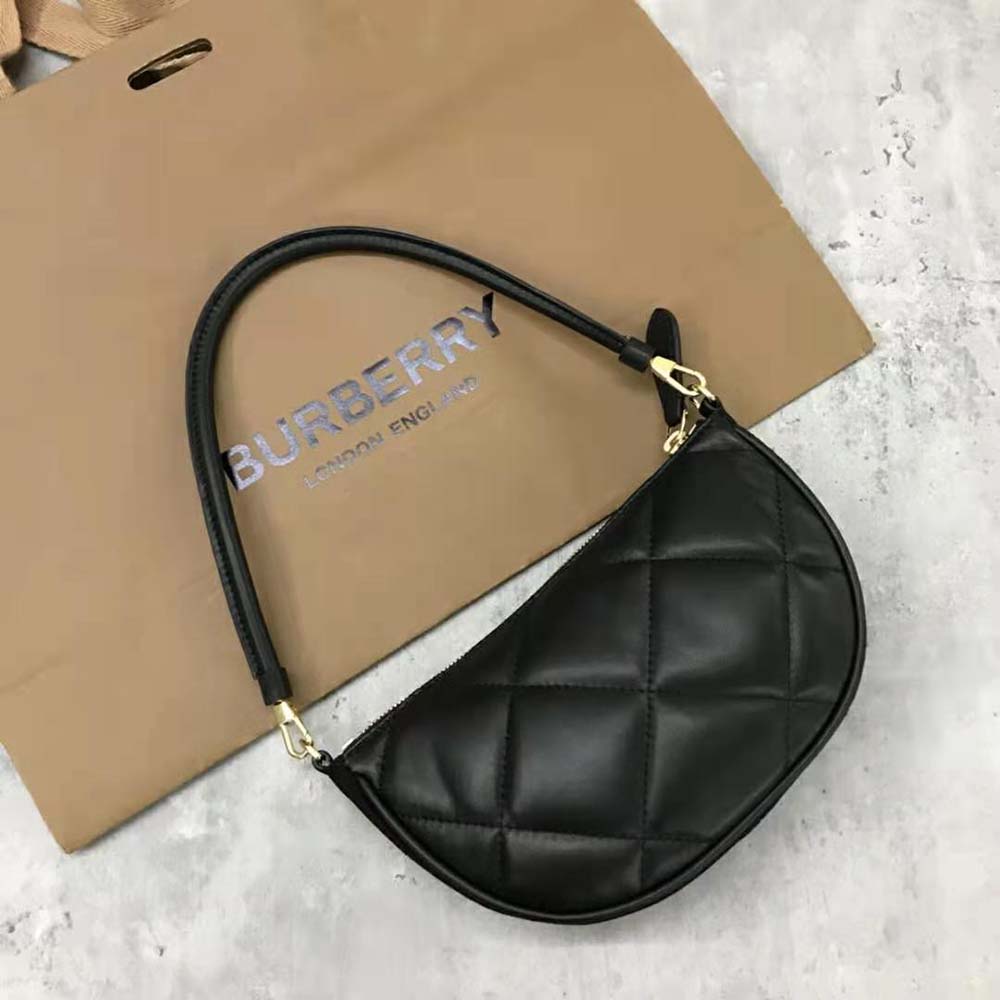 Side angle showing silhouette of Burberry Women Quilted Lambskin Olympia Pouch-Black