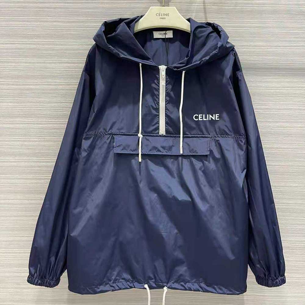 Close-up of zip and Celine logo hardware on blue windbreaker