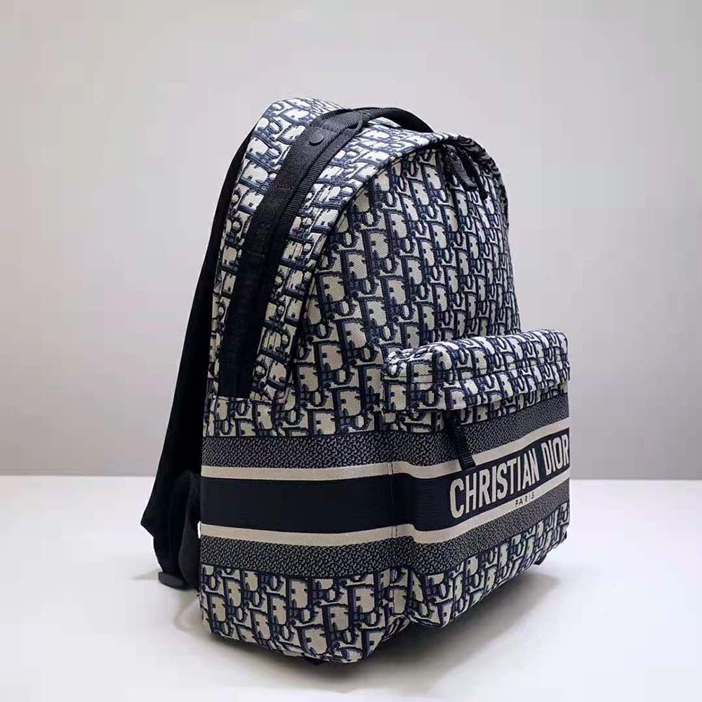 Side angle showing slim profile of Dior Men Travel Backpack blue