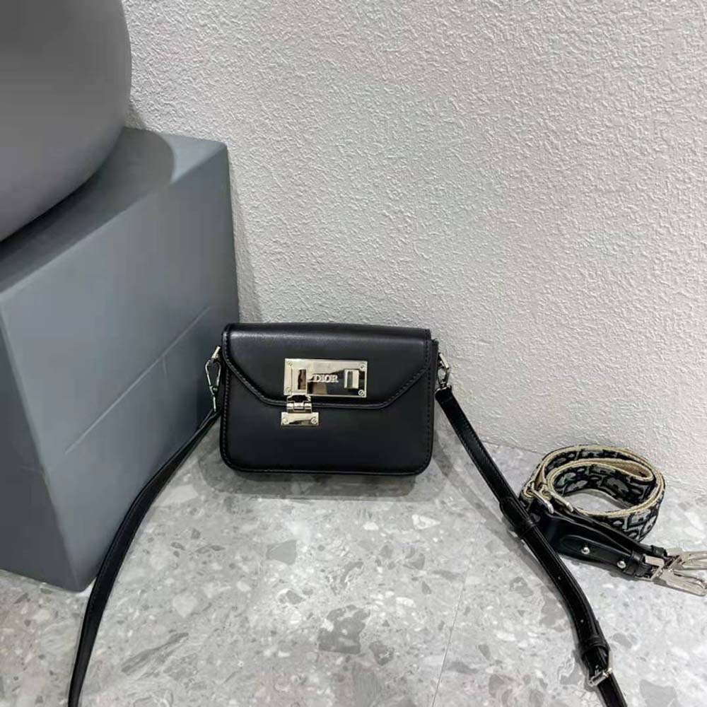 Close-up of silver Dior signature hardware on pouch