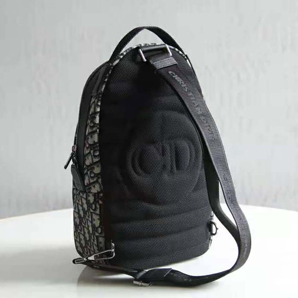 Side angle showing adjustable strap and silver hardware of Dior Men Sling Bag