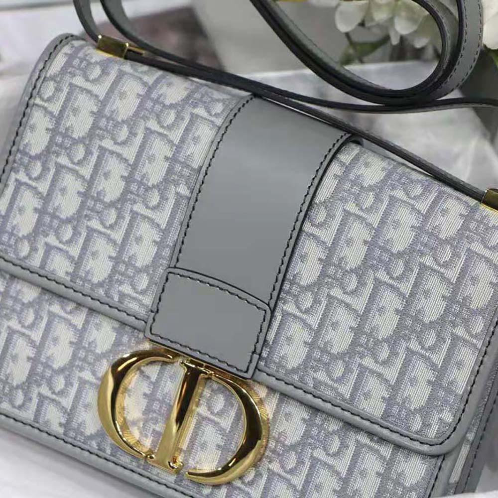 Close-up of silver 'CD' hardware on Dior Women 30 Montaigne Bag Gray
