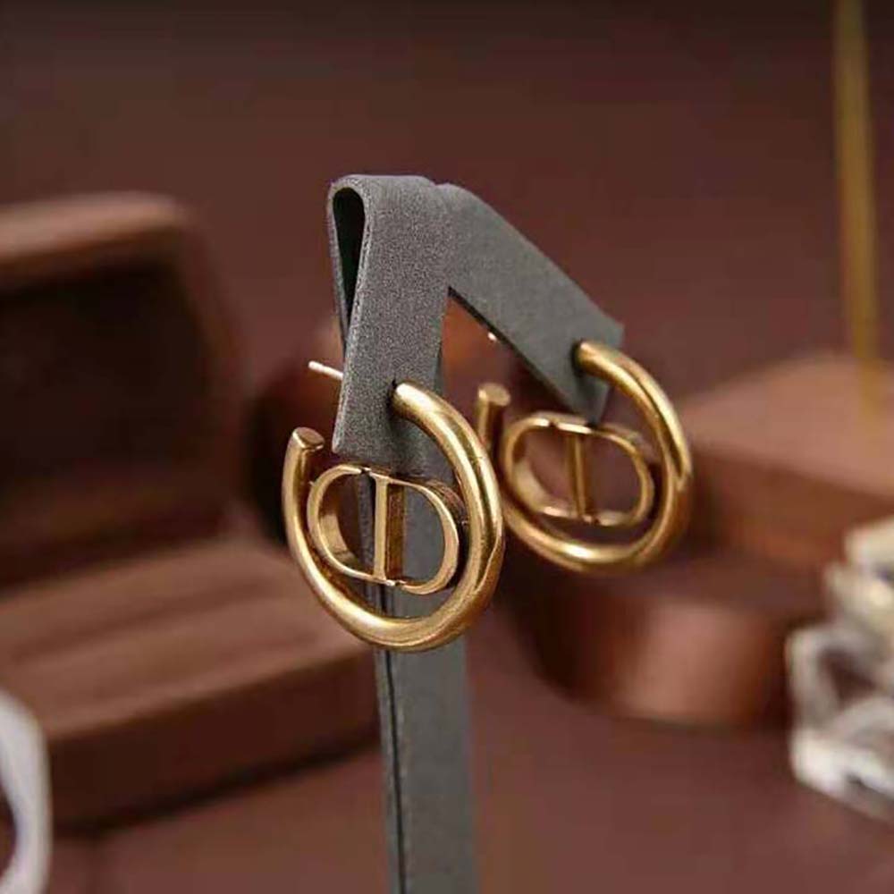 Side profile of Dior Women 30 Montaigne Hoop Earrings highlighting gold finish