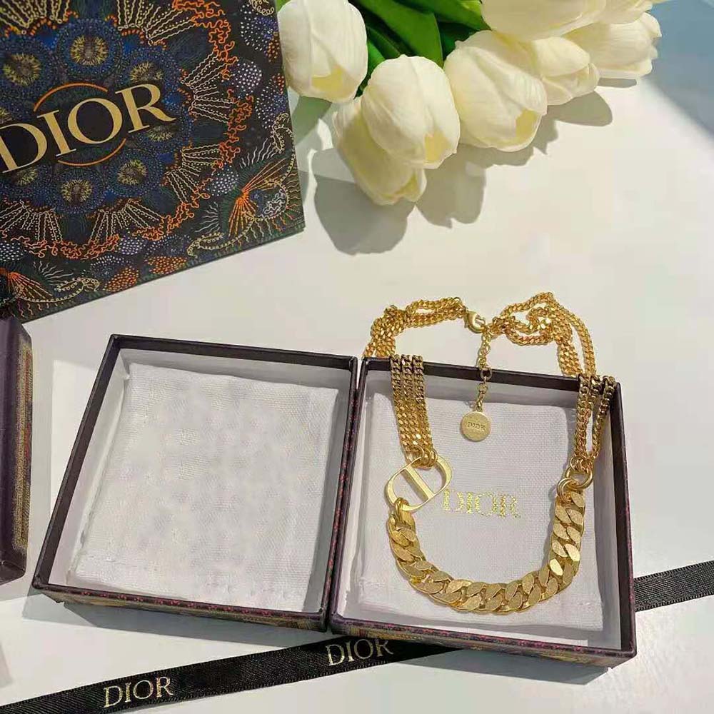 Model wearing Dior Women 30 Montaigne Necklace Gold-Finish Metal with elegant outfit